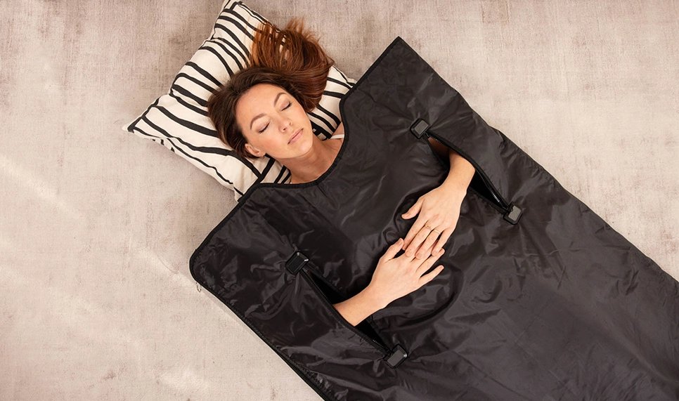 A premium infrared sauna blanket displayed in a bright and peaceful wellness room.
